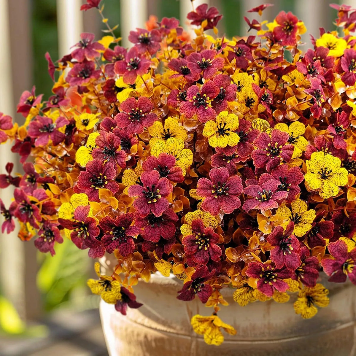 Artificial flower bouquet in autumn colours made from plastic and silk materials.
