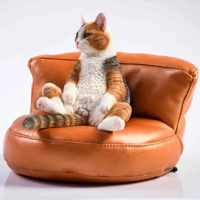 Small resin cat ornament sitting on fabric sofa for car dashboard decoration