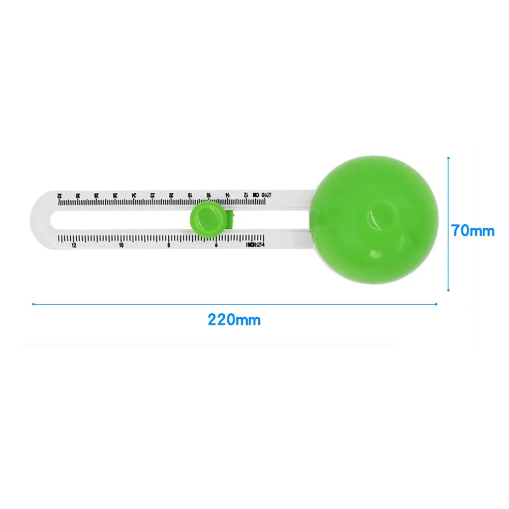 Green and orange plastic round paper cutter for cutting A3 sheets on a desk.
