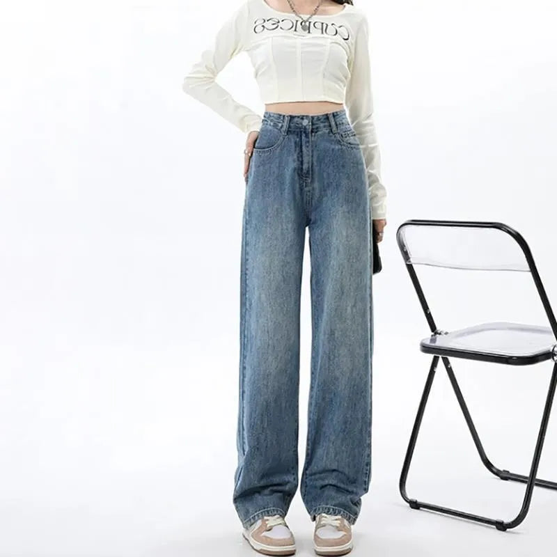 Women's retro blue high-waist wide-leg denim trousers on a hanger, showing straight leg cut.