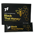 A 300g jar of dark black Thai honey labelled T1, shown with a honey dipper.