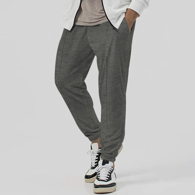 Men's grey cotton blend straight-leg track sweatpants with a tapered fit and elasticated waist.