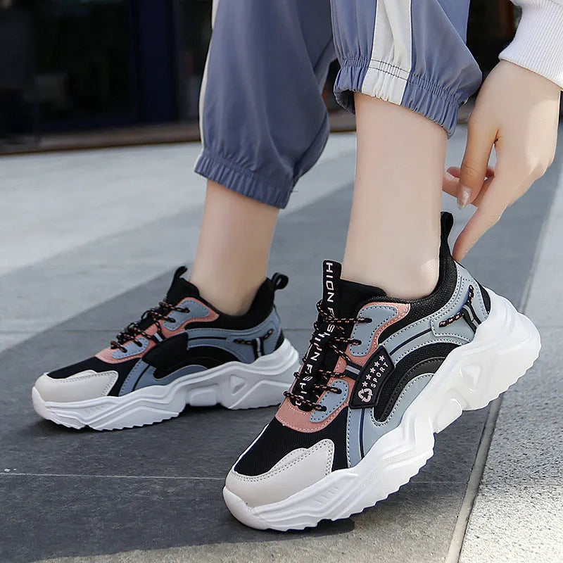 Women's white casual sports shoes with mesh upper, thick PU sole, and a buckle fastening.