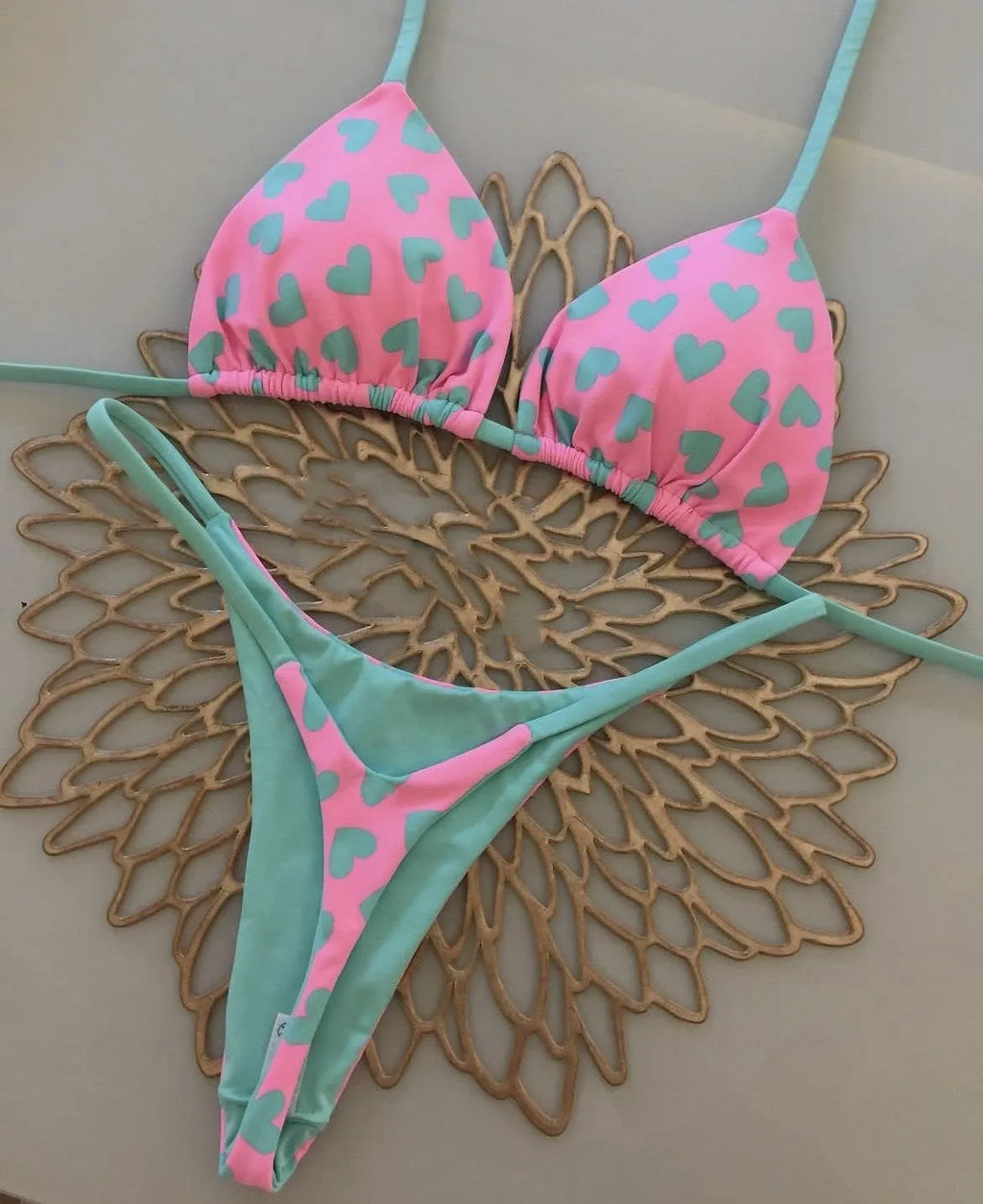 Women's heart print backless swimsuit in briefs style with cotton lining.
