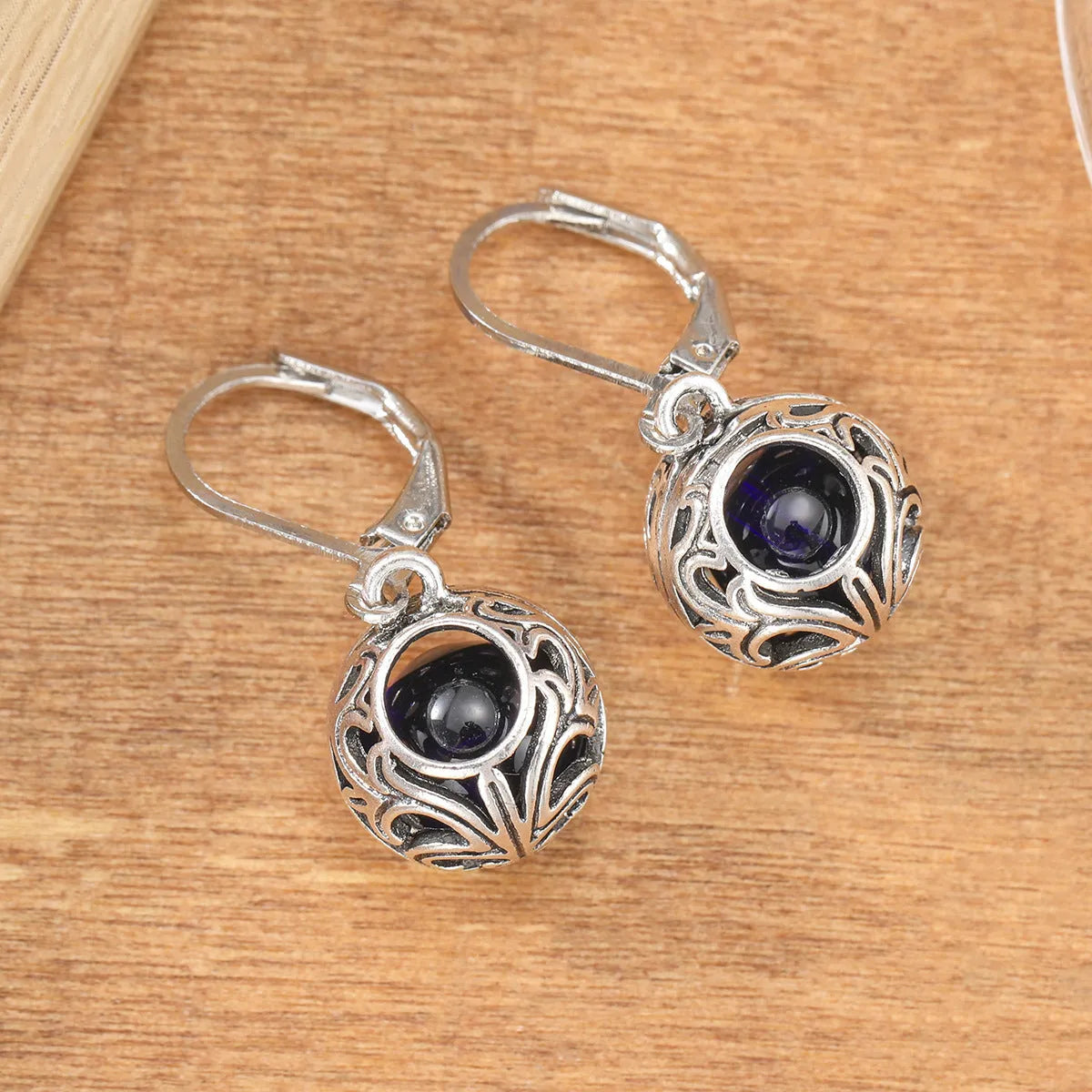 Silver-coloured vintage engraving hollow geometric pendant earrings with blue gemstone