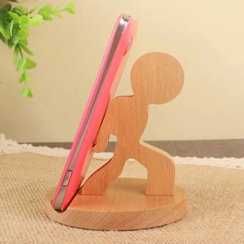 Solid beech wood phone holder with resin puppy decoration and a pound coin in the integrated slot.