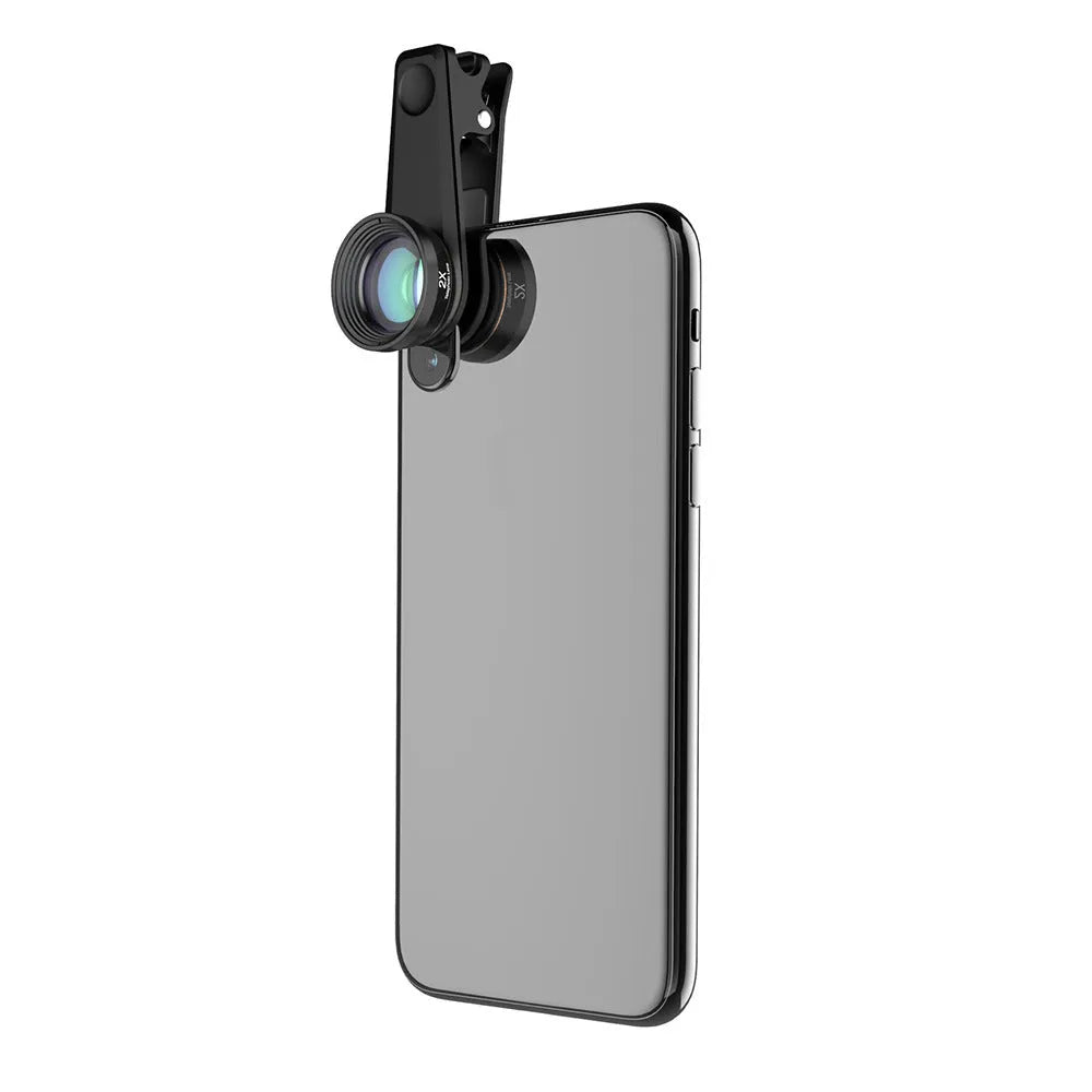 Black 6-in-1 smartphone lens kit with fisheye, macro, telephoto, CPL, and star filters next to a phone on a table.