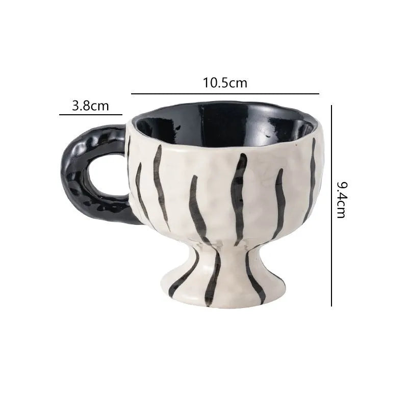 Hand-pinched irregular ceramic mug in a solid colour, showing its unique shape and modern design.
