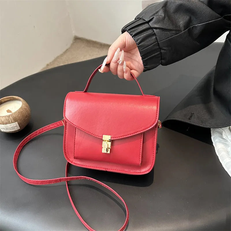 Horizontal square PU leather messenger bag in urban style with crossbody strap and sewing line detail.