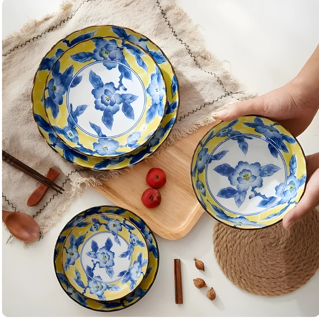 Japanese style ceramic tableware set with underglaze flowers in yellow and colourful patterns round shape