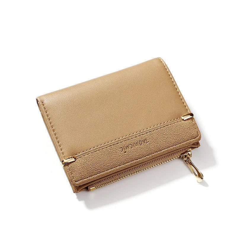 Black ladies short zipper wallet open to show multiple card slots, bill compartment, and change slot.