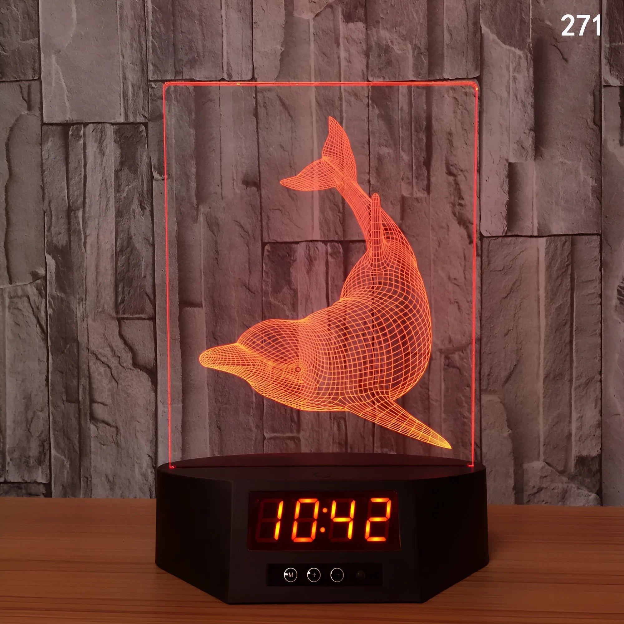 Dolphin-shaped 3D night light table lamp with wireless charging pad and remote control on wooden surface