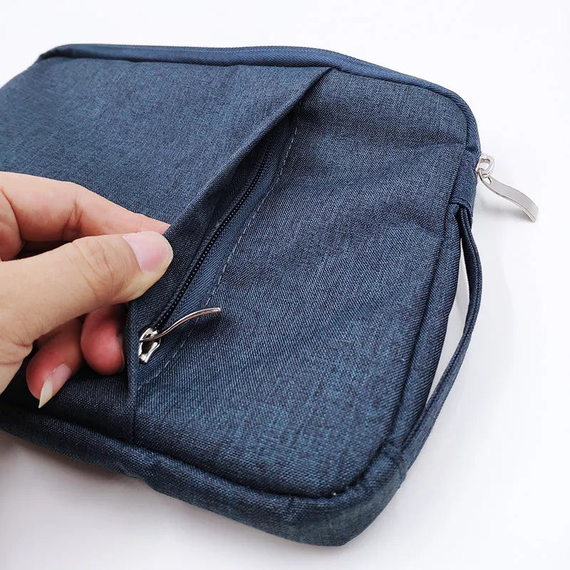 Grey canvas protective sleeve case for an iPad Pro 12.9 tablet on a wooden table.