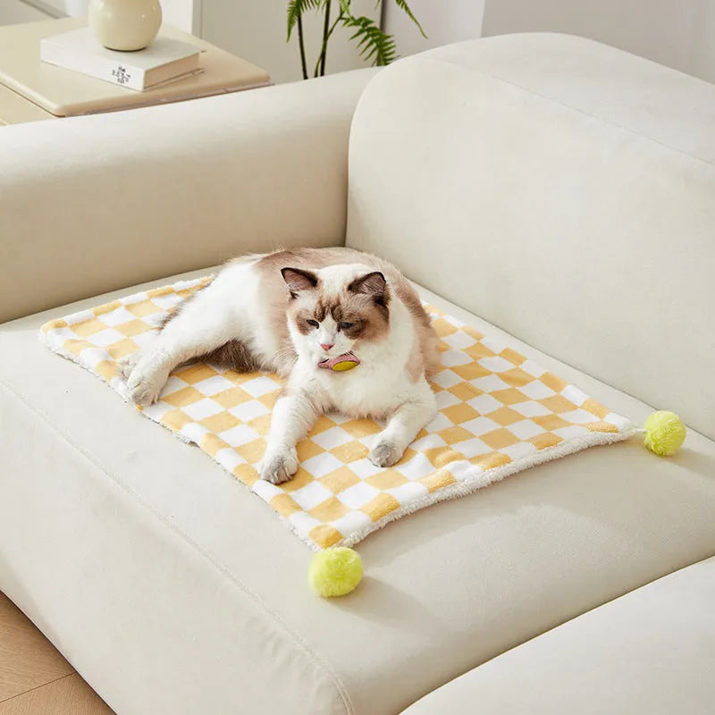 Soft plush pet blanket with plaid pattern and fur ball decoration for cats and dogs