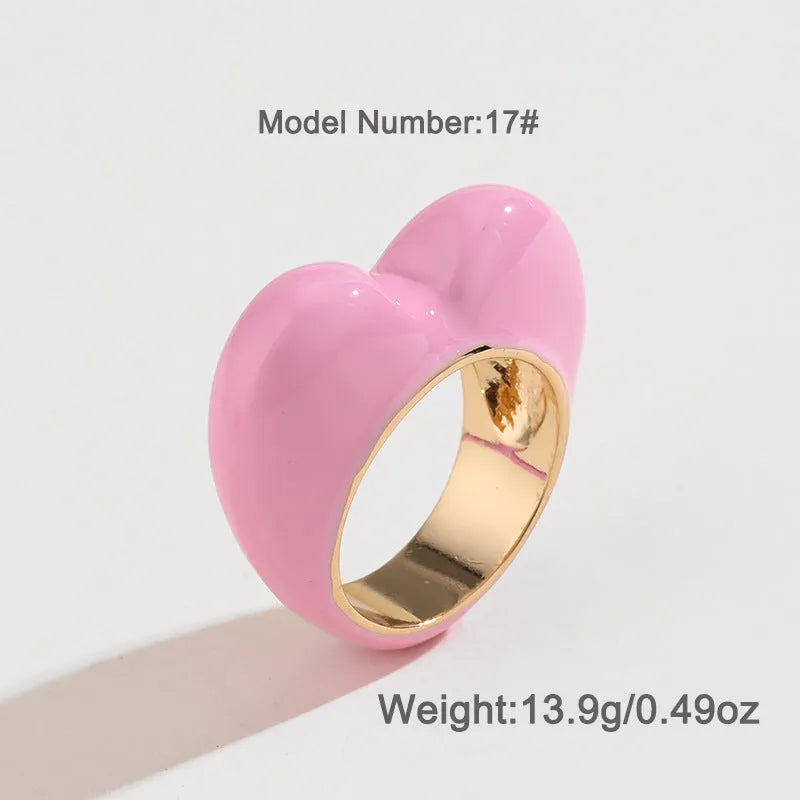 Close-up of a colourful three-dimensional enamel heart ring on a zinc alloy band.