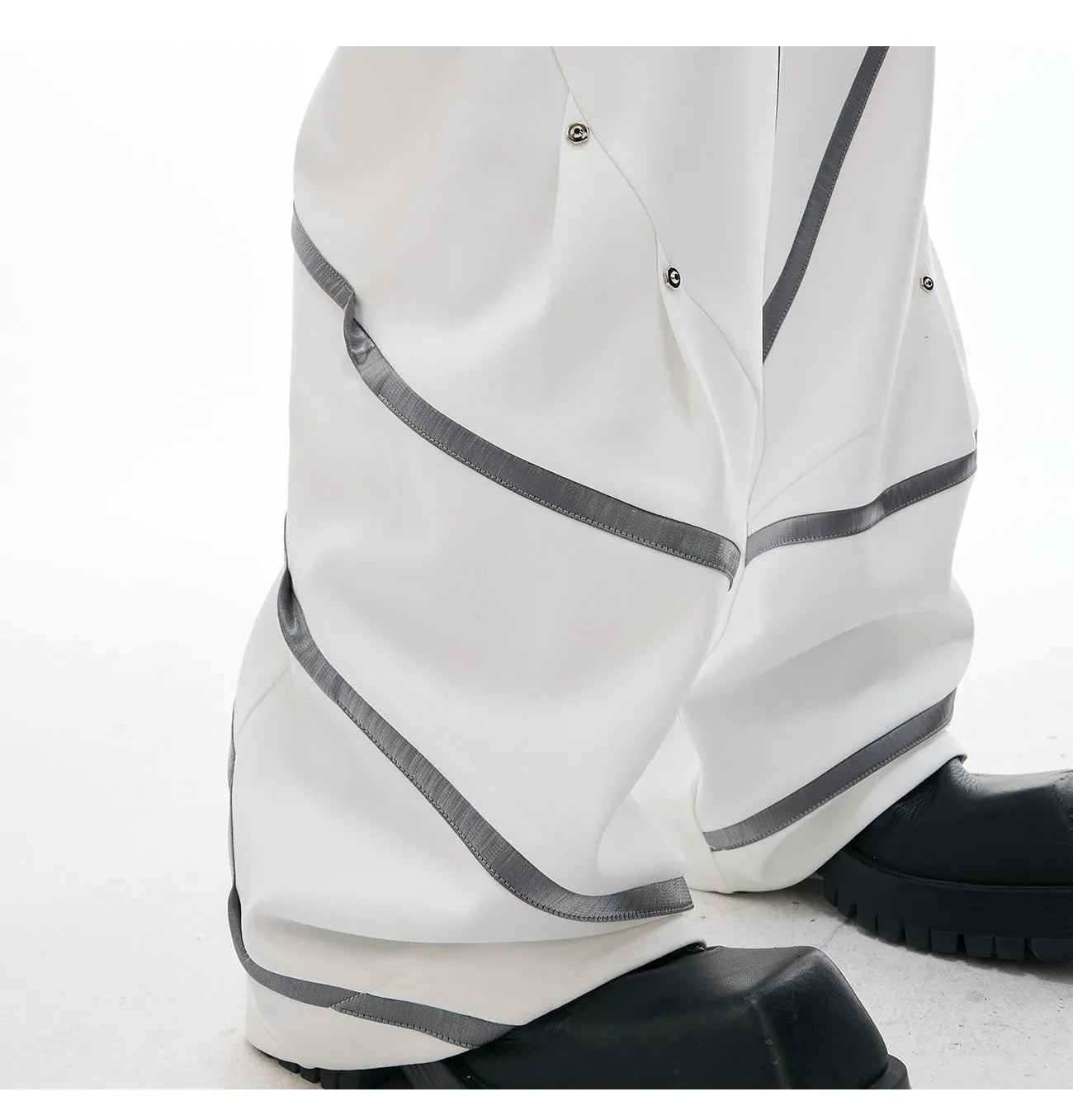 Men's black trousers with deconstructed three-dimensional cutting and metal rivets on the pleats