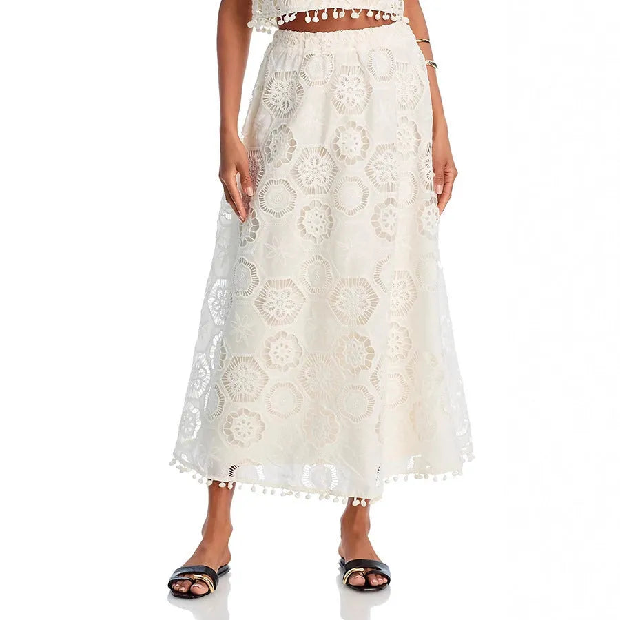 White women's sleeveless top and long skirt suit with embroidery details