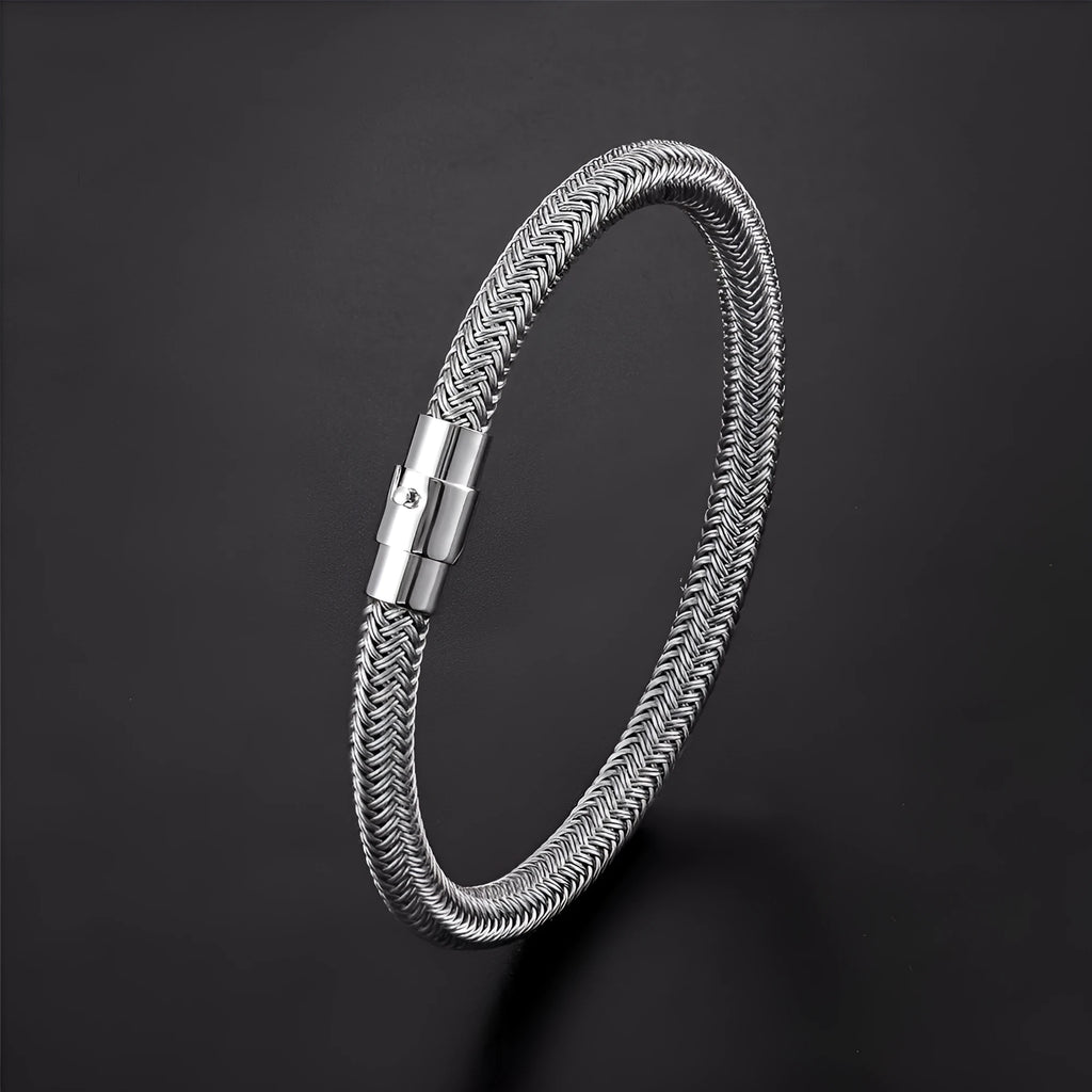 Geometric titanium steel wire bracelet with a magnetic clasp closure on a wrist.