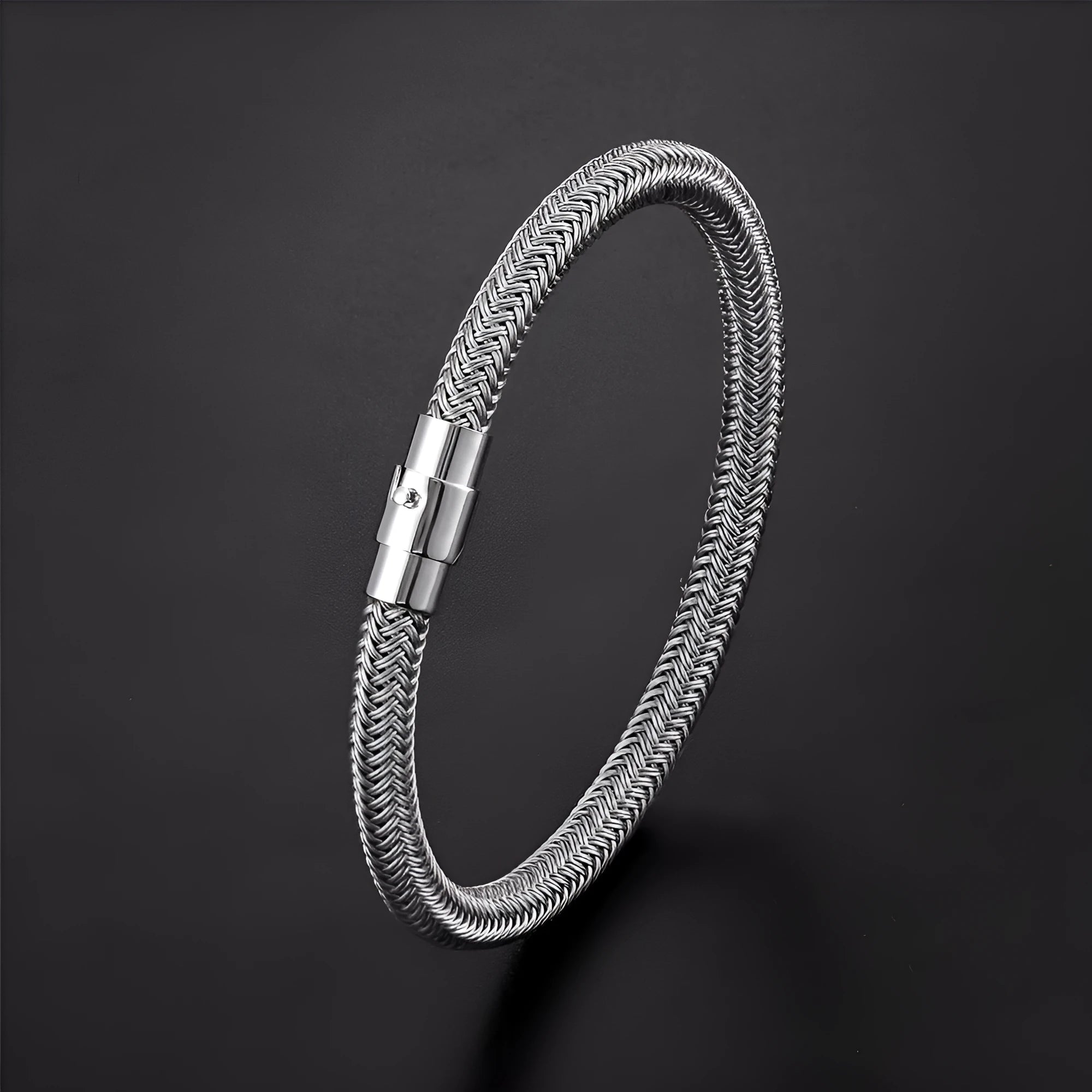 Geometric titanium steel wire bracelet with a magnetic clasp closure on a wrist.