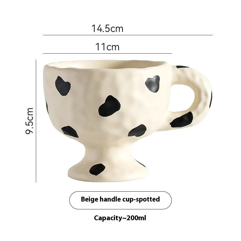 Hand-pinched irregular ceramic mug in a solid colour, showing its unique shape and modern design.