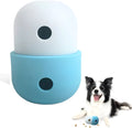 White and blue silicone dog treat puzzle ball toy on a wooden floor.