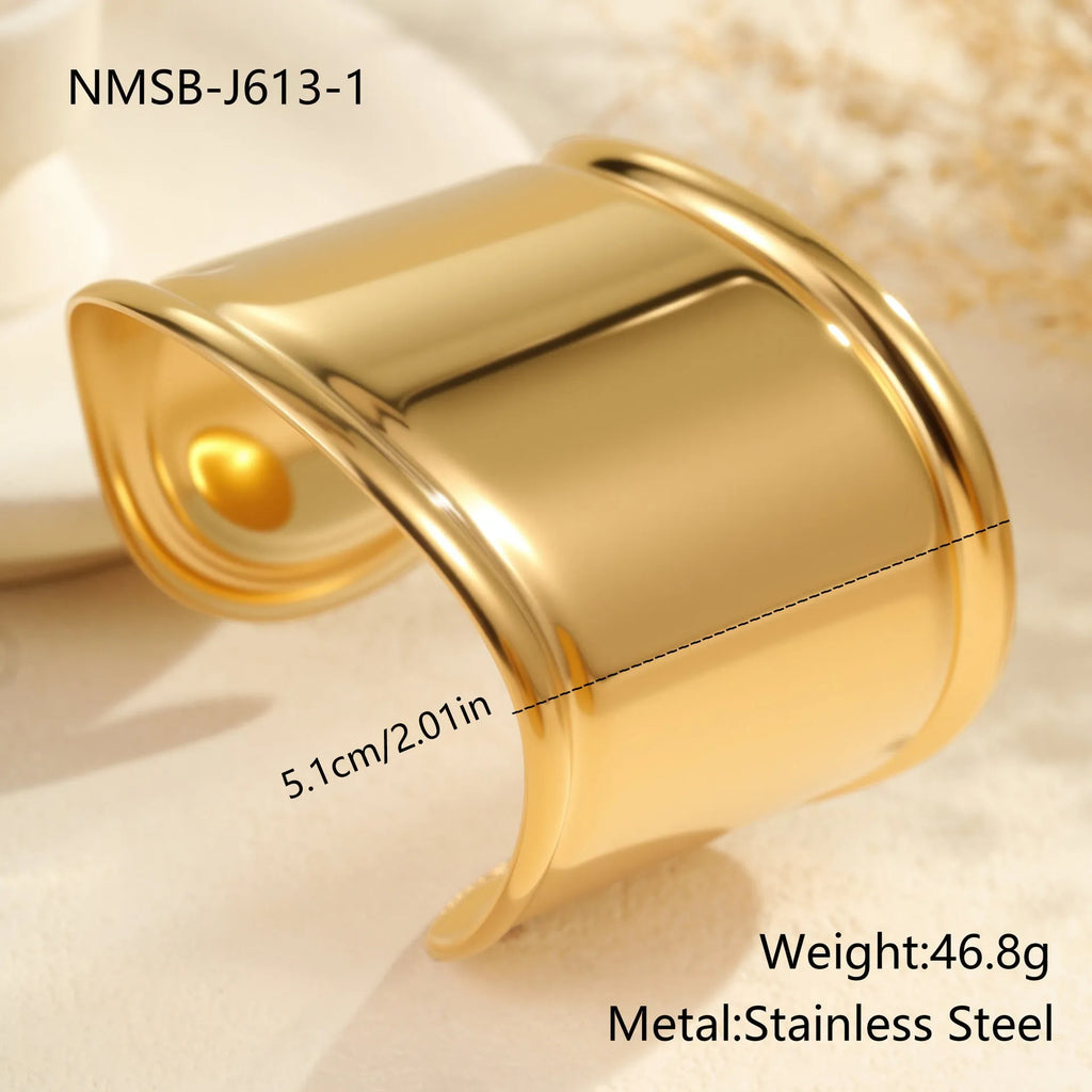 Women's wide stainless steel bracelet with 18K gold plating in a wave and geometric design.