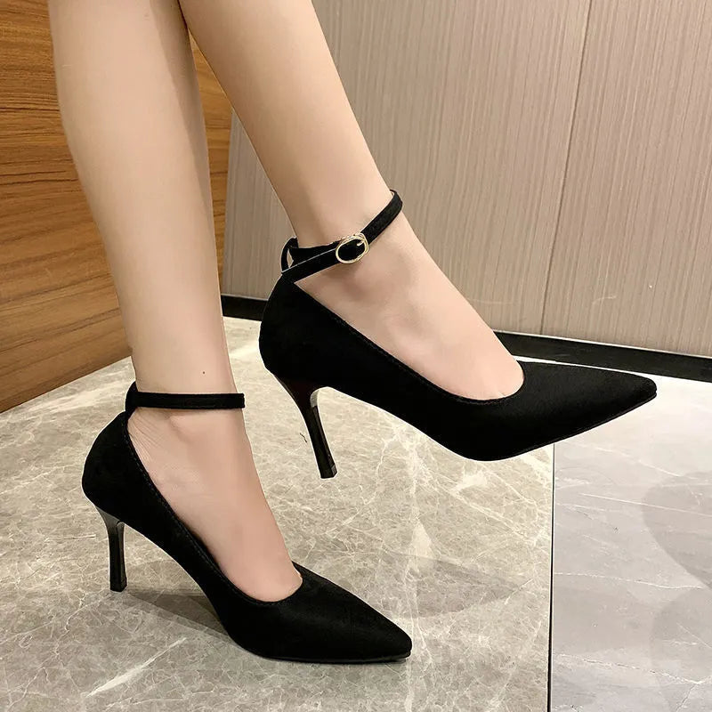 Black women's stiletto heel pump shoe with a skull pattern and a buckle fastening.