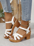 Plus size black peep toe high heel sandals with a chunky heel and ankle strap buckle on a white background.
