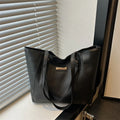 Large capacity women's retro PU shoulder bag in black with double connector straps and three-dimensional outer pocket