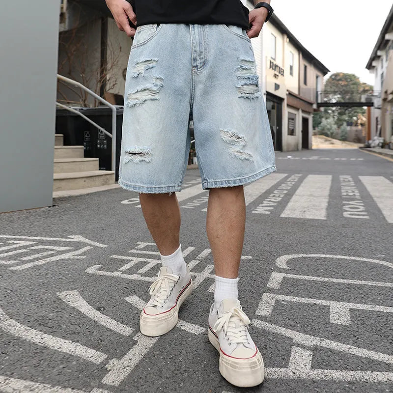 Light blue ripped denim shorts with distressed detailing and straight leg hip hop styling