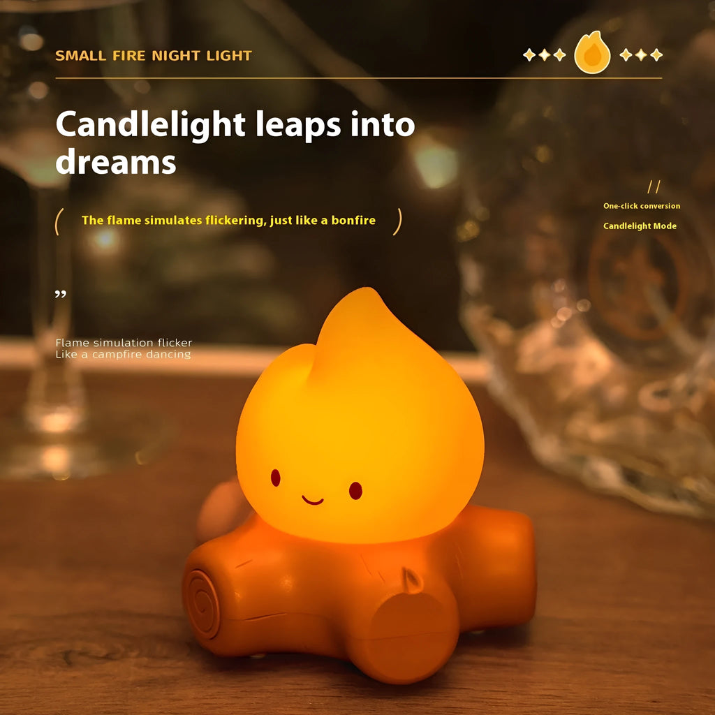 Silicone small fire pile cartoon night lamp with ABS shade on a surface.