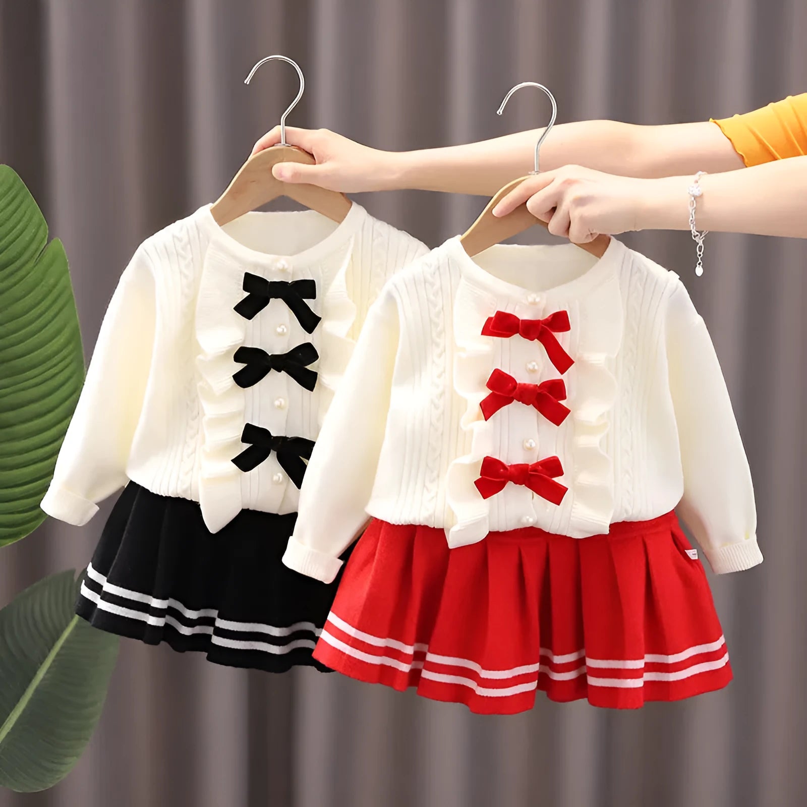Knitted baby girl two-piece skirt suit in pink with bow detail and long sleeves, autumn wear