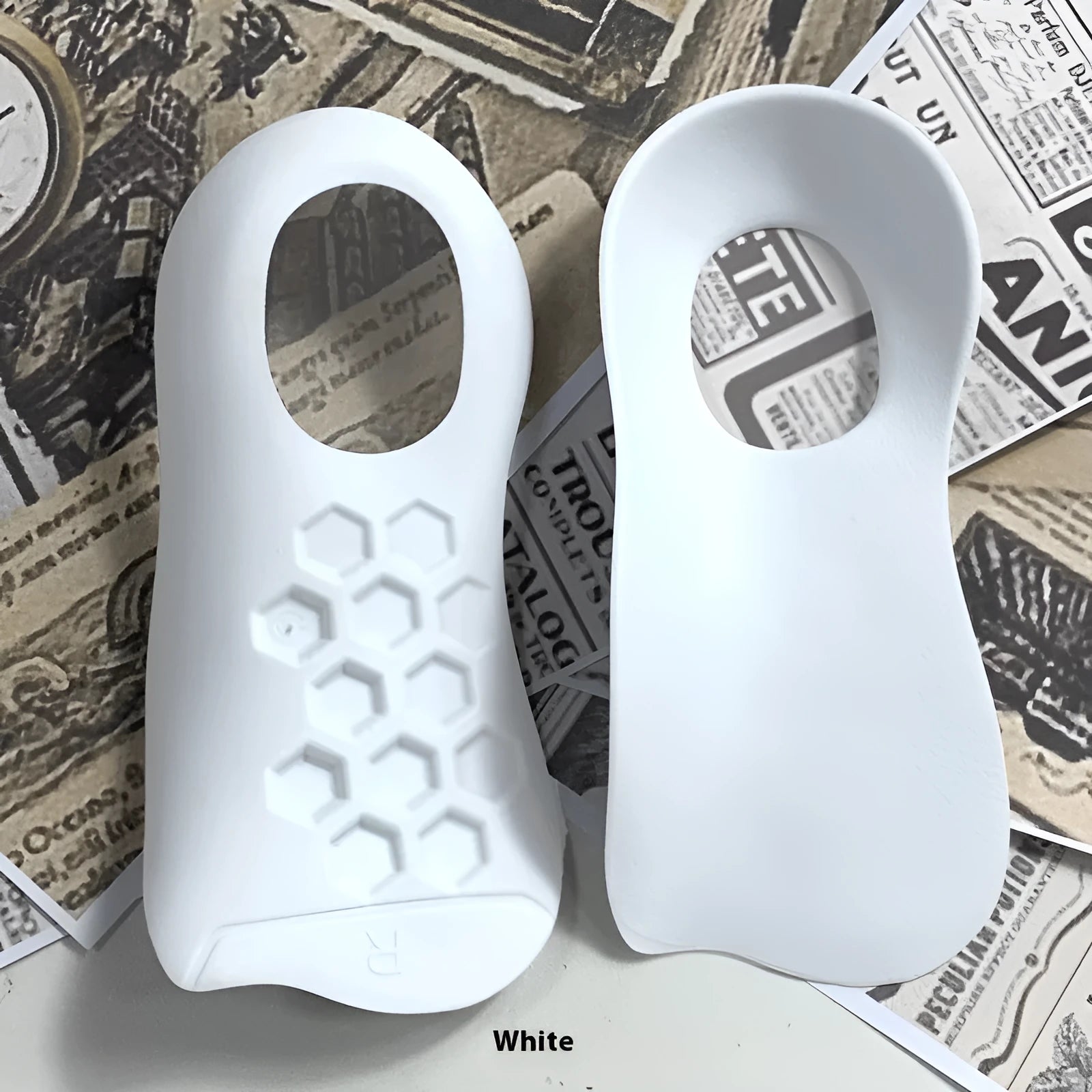 Pair of varus correction arch support insoles in TPR material on a white background.