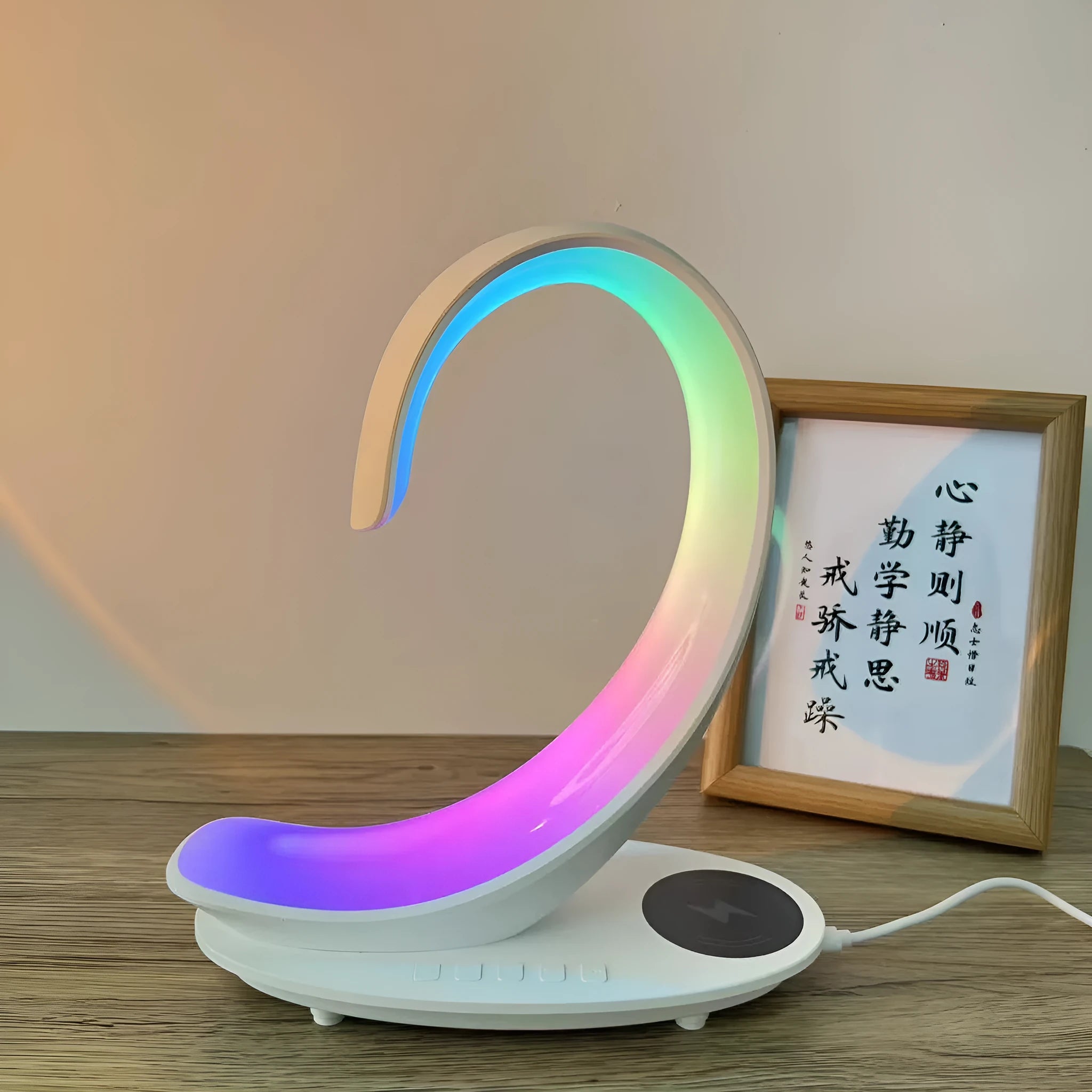 White swan-shaped desktop device functioning as a wireless charger, Bluetooth speaker, and colourful LED atmosphere lamp.