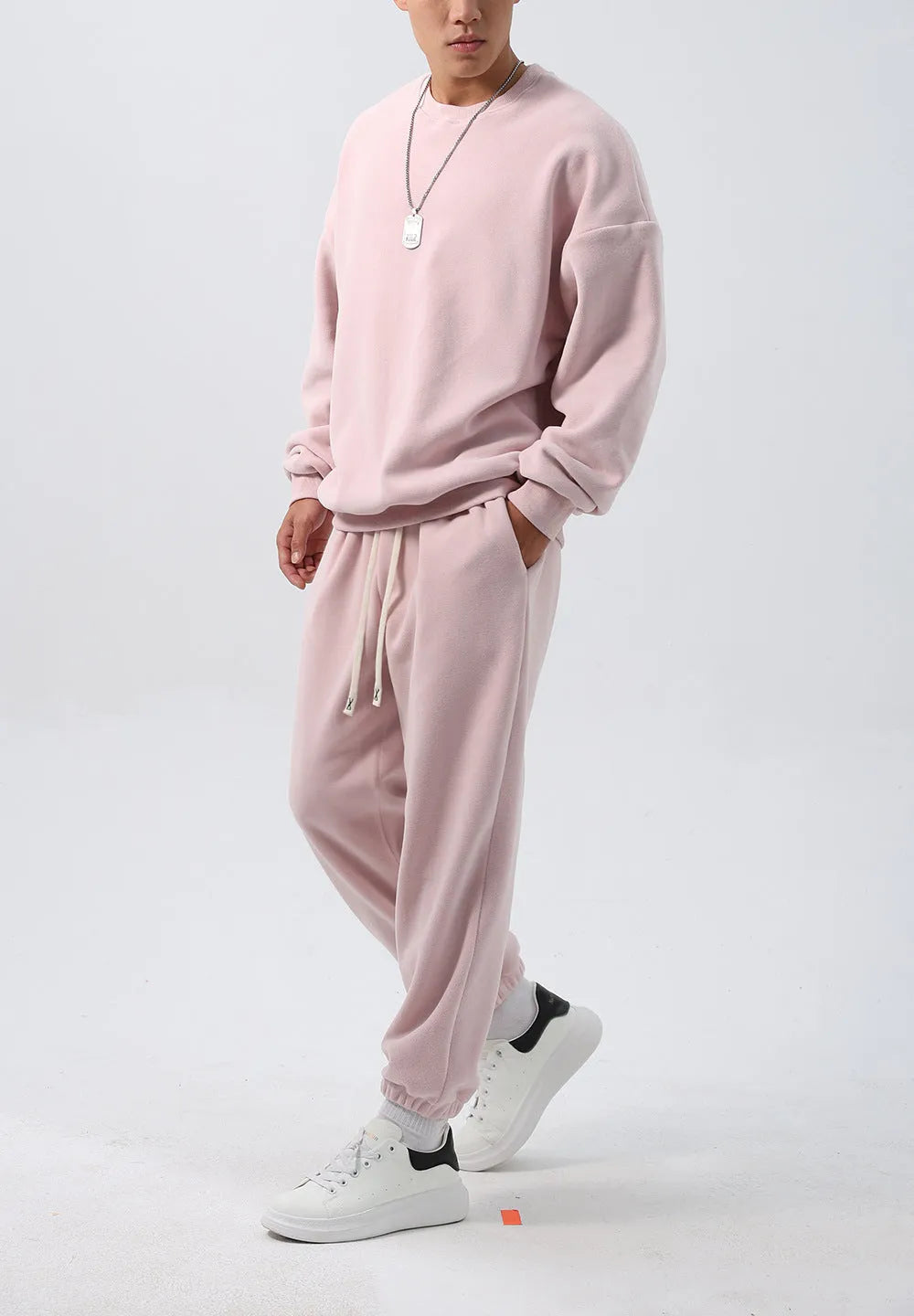 Men's polar fleece sports suit set showing crew neck top with long sleeves and matching padded trousers in winter colours