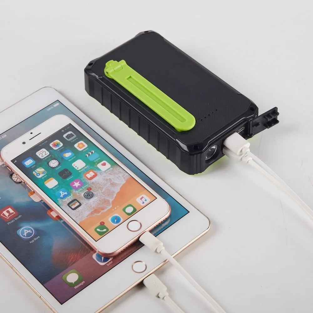 Green and orange hand crank solar power bank with unfolded solar panel and dual USB ports