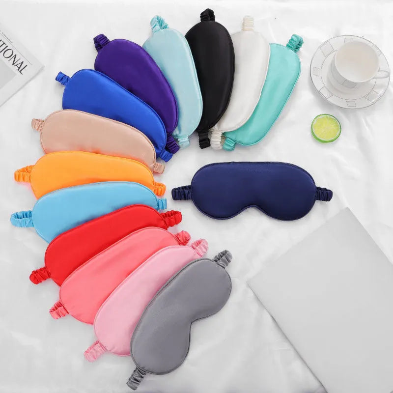 Rayon satin double-sided sleep mask in a selection of solid colours on a white background.