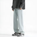 Men's light blue washed straight leg jeans with button waist closure showing cotton denim fabric texture