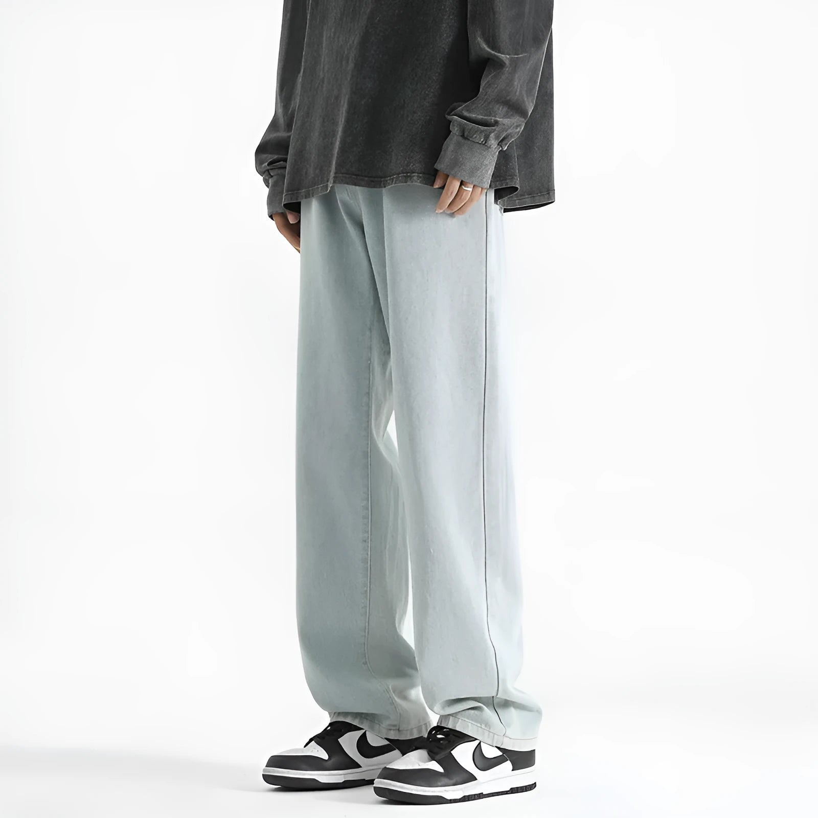 Men's light blue washed straight leg jeans with button waist closure showing cotton denim fabric texture