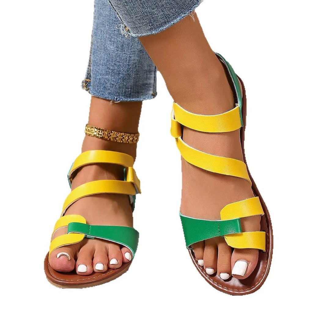 Women's flat sandals with Velcro straps in PU, showing round toe and rubber sole.