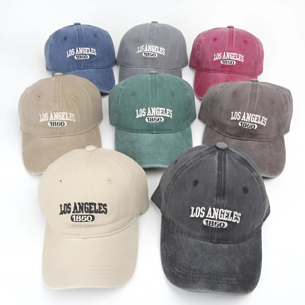 Retro-style personalised embroidered peaked cap with adjustable strap on distressed beige fabric.