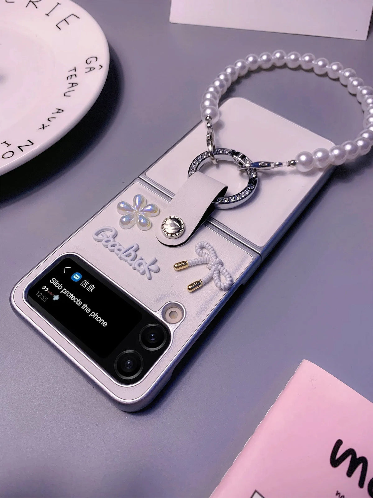 Ultra thin faux leather folding phone case for Samsung Galaxy Z Flip with white silver border, flower bow and bracelet