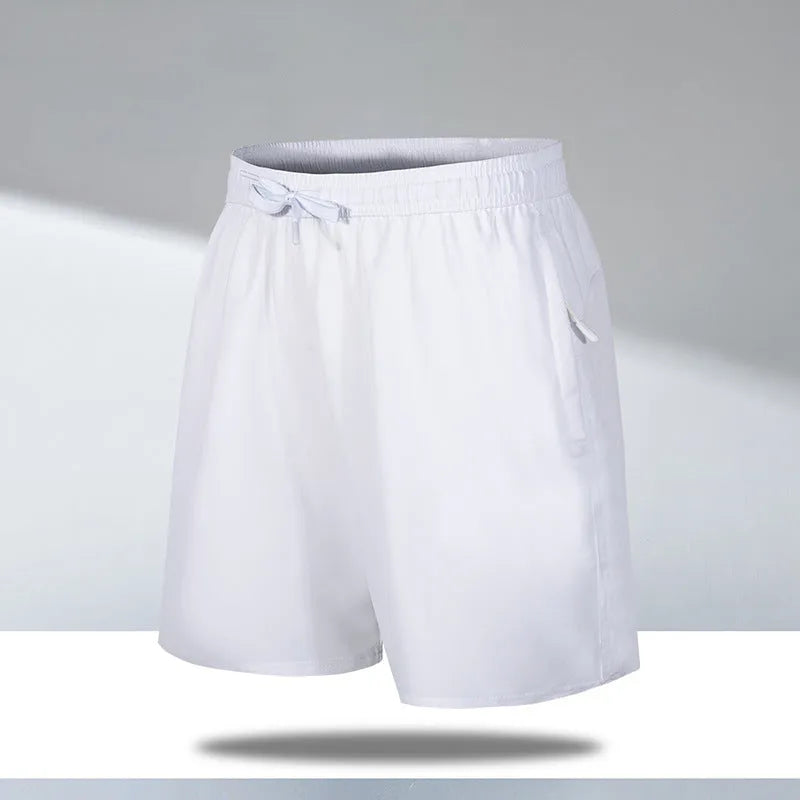 Man wearing loose-fit black quick-drying ice silk polyester beach shorts with an elasticated waist.