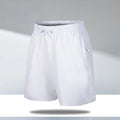 Man wearing loose-fit black quick-drying ice silk polyester beach shorts with an elasticated waist.