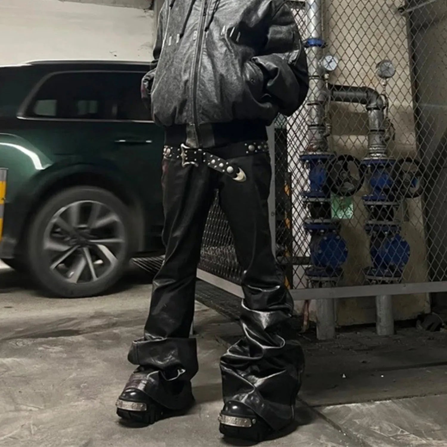 Black skinny jeans with shiny patent leather coating and straight-leg cut
