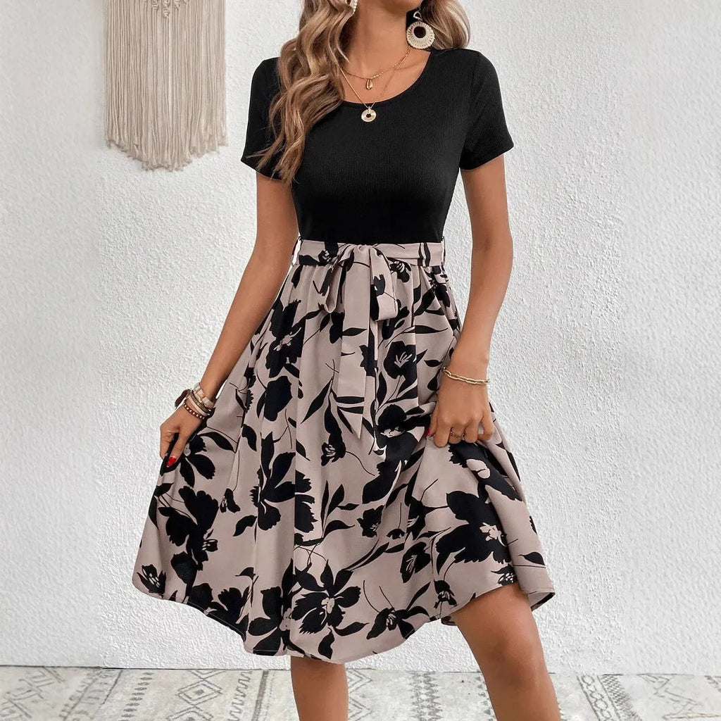 Women's khaki A-line dress with botanical printing, lace-up detail, and a shoulder strap.