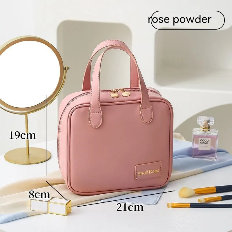 PU leather travel makeup bag in caramel mocha, 21x8x19cm, open to show compartments for cosmetics and toiletries