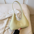 Women's brown retro PU leather shoulder handbag with a pillow shape and single strap.