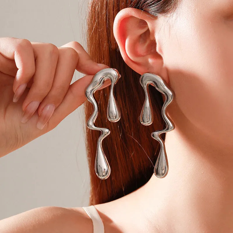 Liquid irregular geometric ear studs in gold, made from zinc alloy with electroplated finish, unique water drop design for women