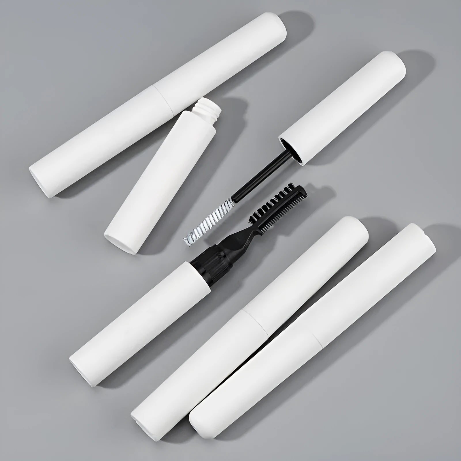 Eyebrow glue with brush applicator for shaping natural eyebrows, available in pink and white transparent formulas